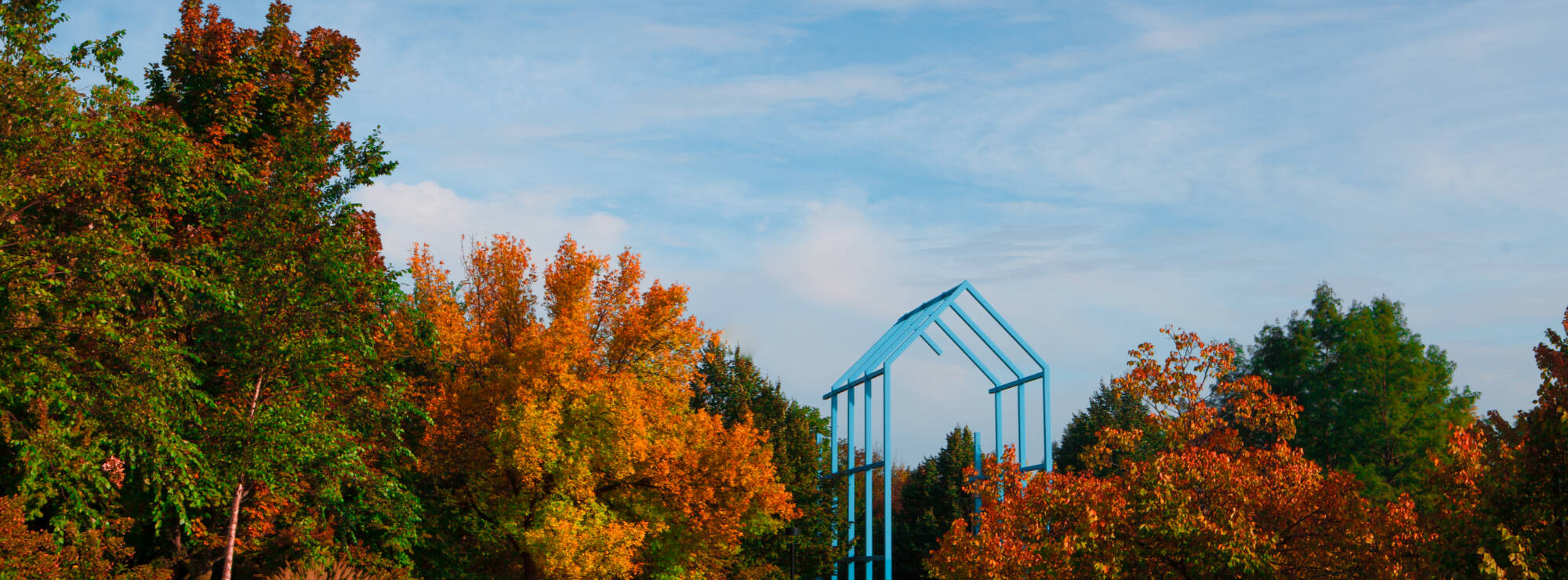 image of a blue structure surrounded by fall foliage.
